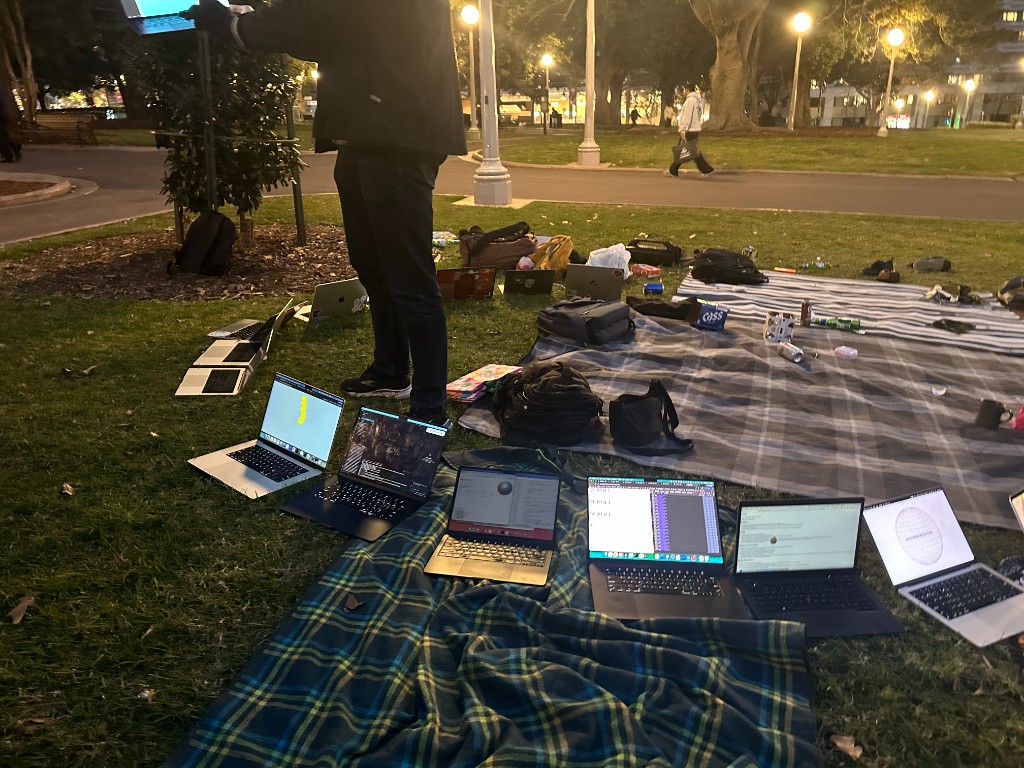 Laptops on picnic blankets under park lights at HTML in Hyde #2